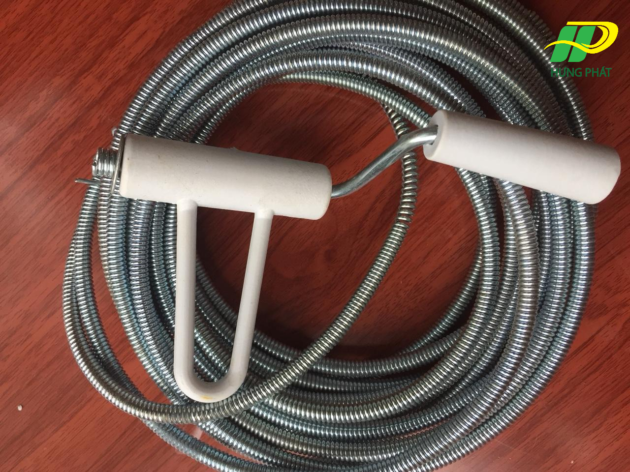 Sử dụng dây lò xo có tay quay thông tắc bồn cầu bệt